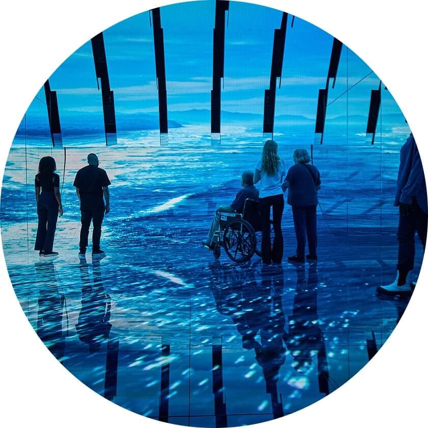 Visitors at the Blue Paradox exhibit learning about the ocean plastic crisis and its impact.